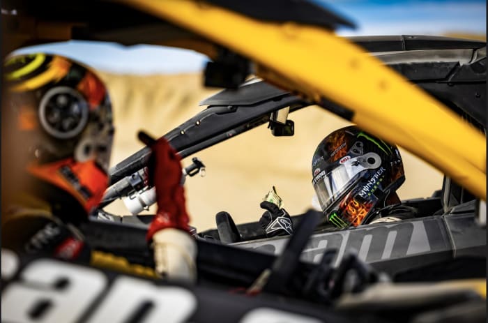 Brian Deegan (right) and Travis Pastrana (left) go through their pre-race strategy before flying through the sand dunes in Southern California. Photo: Long Nguyen.